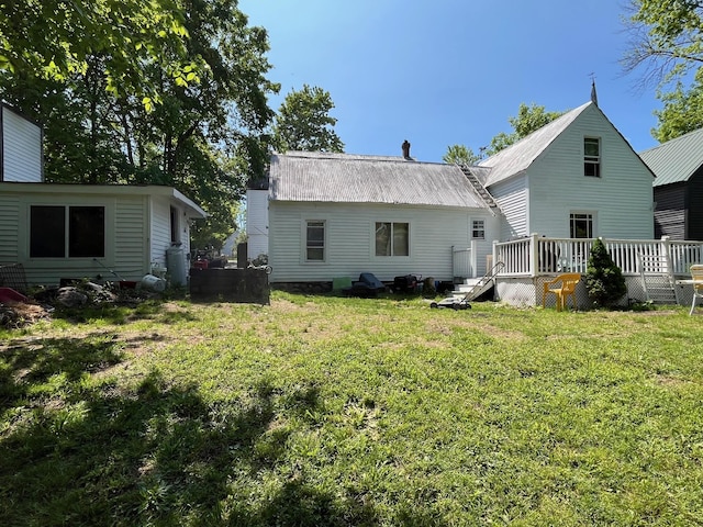 96 French St, Acton, ME 04001 - rear view of house with a wooden deck, metal roof, and a yard