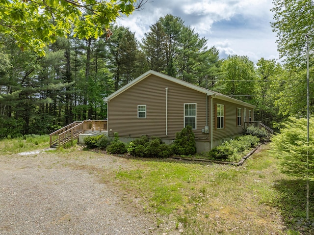 155 Crystal Cv, Waldoboro, ME 04572 - view of property exterior featuring a view of trees, stairs, and a deck