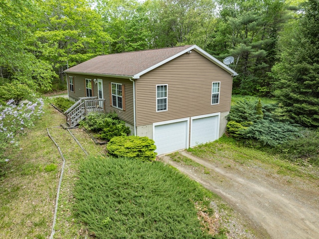 155 Crystal Cv, Waldoboro, ME 04572 - view of front of property with dirt driveway, roof with shingles, and a garage
