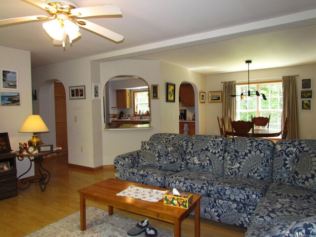 155 Crystal Cv, Waldoboro, ME 04572 - living area with wood finished floors, plenty of natural light, arched walkways, and a ceiling fan