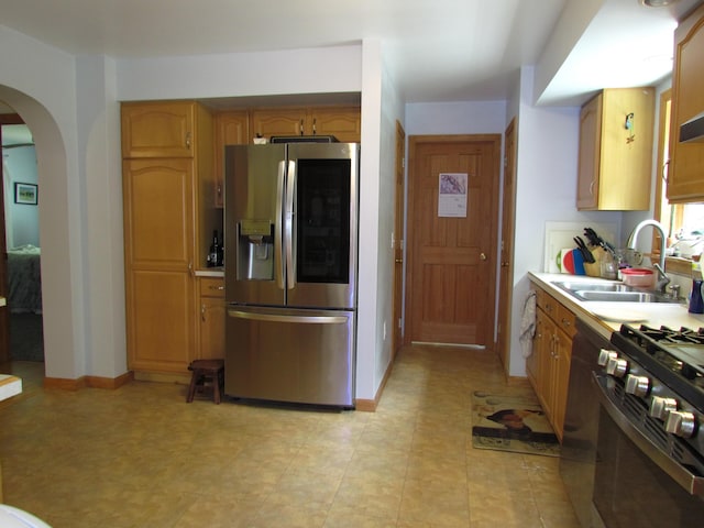 155 Crystal Cv, Waldoboro, ME 04572 - kitchen with appliances with stainless steel finishes, a sink, arched walkways, and light countertops