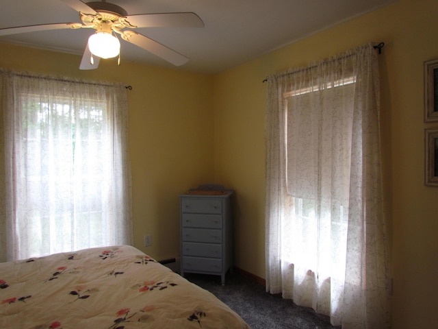 155 Crystal Cv, Waldoboro, ME 04572 - bedroom with dark carpet, a baseboard radiator, and a ceiling fan