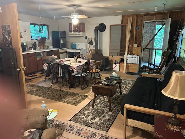 12 Beach View Rd, Dover-Foxcroft, ME 04426 - living area with a wood stove, ceiling fan, and wood finished floors