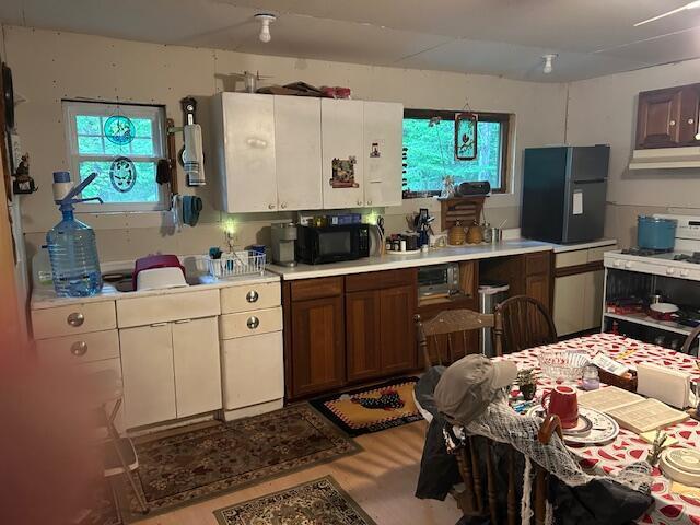 12 Beach View Rd, Dover-Foxcroft, ME 04426 - kitchen featuring black appliances, light countertops, and plenty of natural light