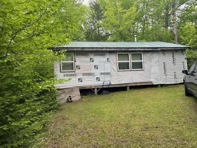 12 Beach View Rd, Dover-Foxcroft, ME 04426 - back of house featuring a yard and metal roof