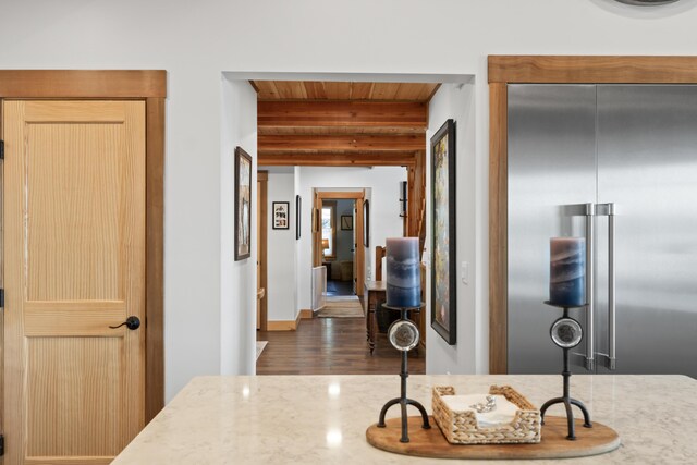 134 Zakelo Rd, Harrison, ME 04040 - kitchen with high end fridge, wood ceiling with exposed beams, light stone counters, wood finished floors, and baseboards