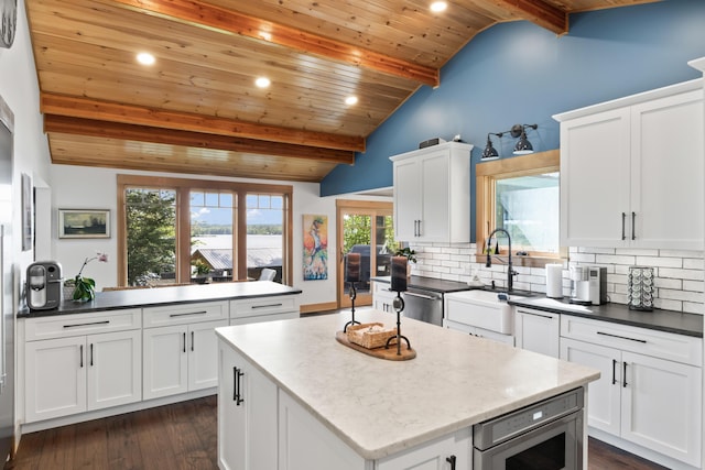 134 Zakelo Rd, Harrison, ME 04040 - kitchen featuring wooden ceiling, a sink, decorative backsplash, a center island, and plenty of natural light