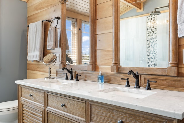 134 Zakelo Rd, Harrison, ME 04040 - bathroom with double vanity, vaulted ceiling, and toilet