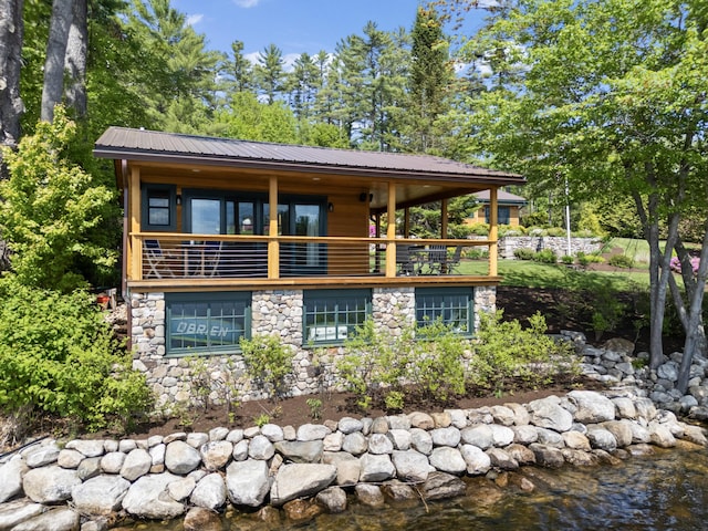 134 Zakelo Rd, Harrison, ME 04040 - chalet / cabin featuring stone siding, a balcony, metal roof, and a water view