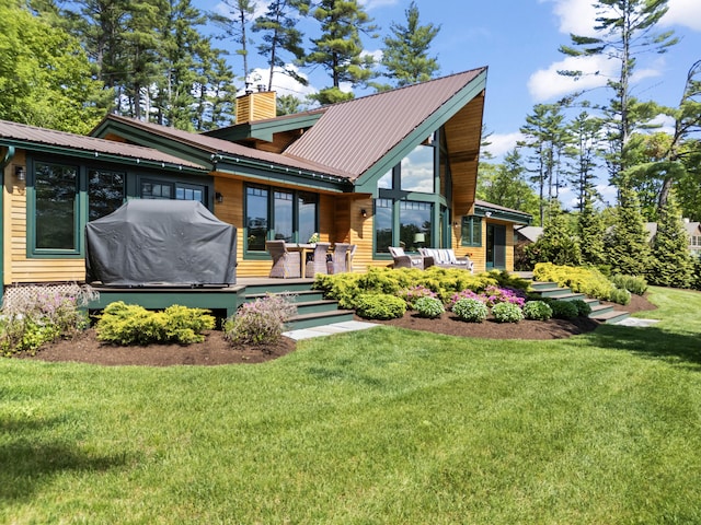 134 Zakelo Rd, Harrison, ME 04040 - rear view of house featuring a chimney, a lawn, a wooden deck, and metal roof