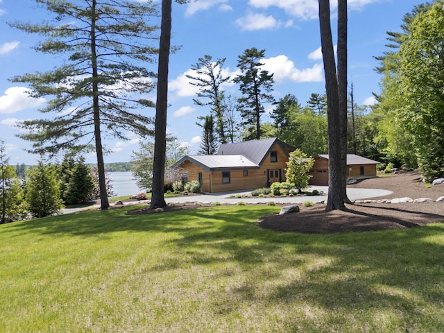 134 Zakelo Rd, Harrison, ME 04040 - view of green lawn with a water view, a garage, and driveway