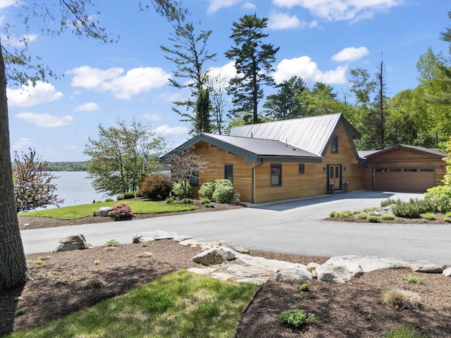 134 Zakelo Rd, Harrison, ME 04040 - view of side of home with a detached garage, a water view, metal roof, and asphalt driveway