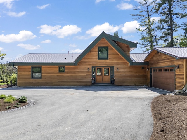 134 Zakelo Rd, Harrison, ME 04040 - view of front of house with asphalt driveway, metal roof, and an attached garage