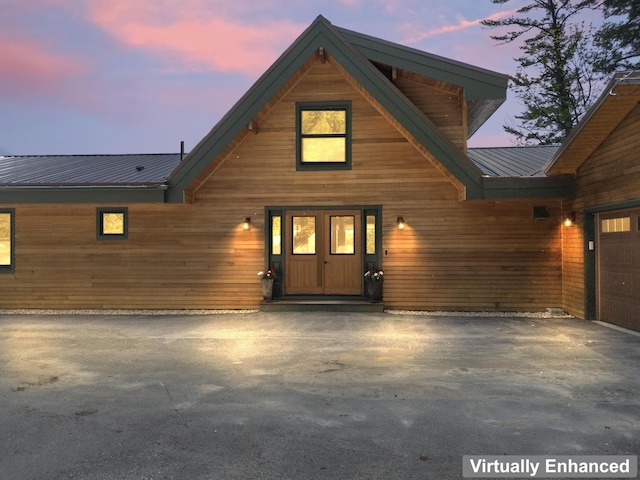 134 Zakelo Rd, Harrison, ME 04040 - exterior entry at dusk with asphalt driveway and metal roof