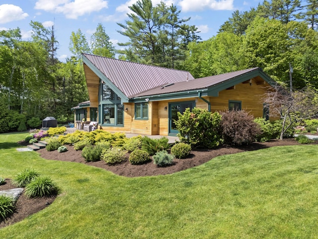 134 Zakelo Rd, Harrison, ME 04040 - view of front of property with a front yard, a patio, and metal roof