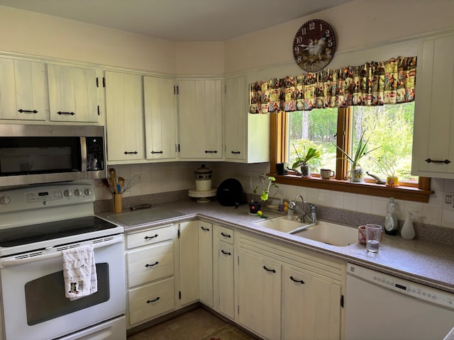 16 Steamboat St, Calais, ME 04619 - kitchen featuring white appliances, a sink, decorative backsplash, and light countertops