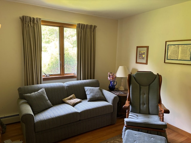 16 Steamboat St, Calais, ME 04619 - living area featuring wood finished floors and a baseboard heating unit