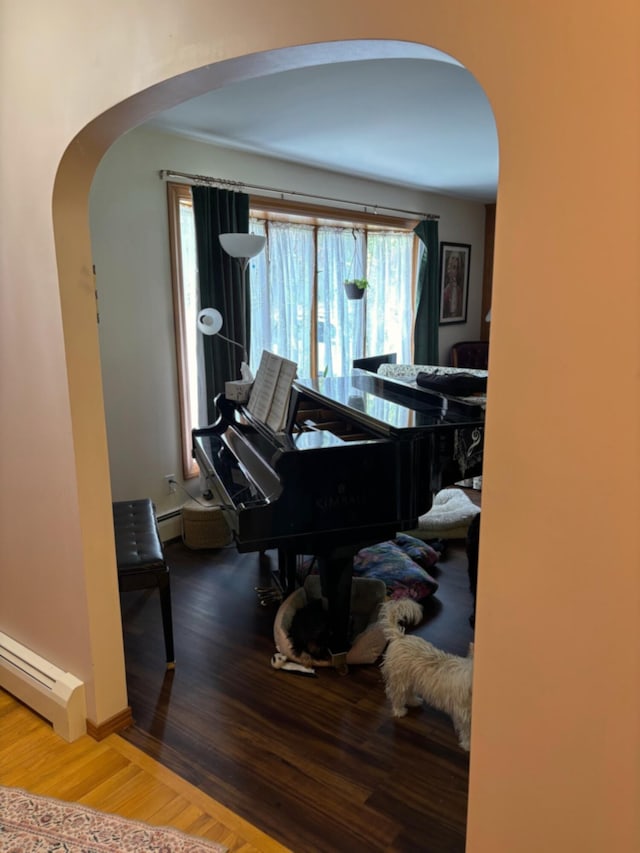 16 Steamboat St, Calais, ME 04619 - sitting room with arched walkways, baseboard heating, and wood finished floors