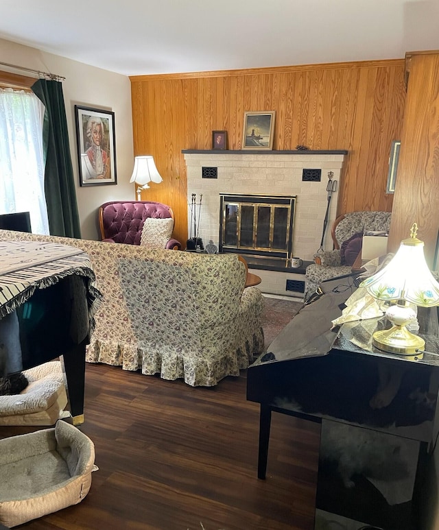 16 Steamboat St, Calais, ME 04619 - living area with a brick fireplace, dark wood-style floors, and wood walls