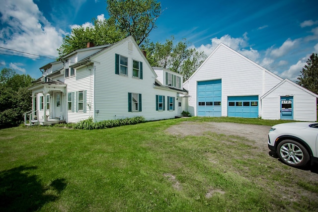 31 Village St, Jefferson, ME 04348 - view of property exterior featuring a garage, a lawn, and a chimney