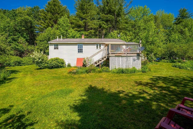 129 Lawrence Rd, Gray, ME 04039 - rear view of house with a deck, a yard, a forest view, stairs, and a chimney