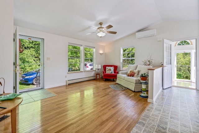 129 Lawrence Rd, Gray, ME 04039 - living area featuring a baseboard radiator, a wall mounted air conditioner, a ceiling fan, vaulted ceiling, and light wood-style floors