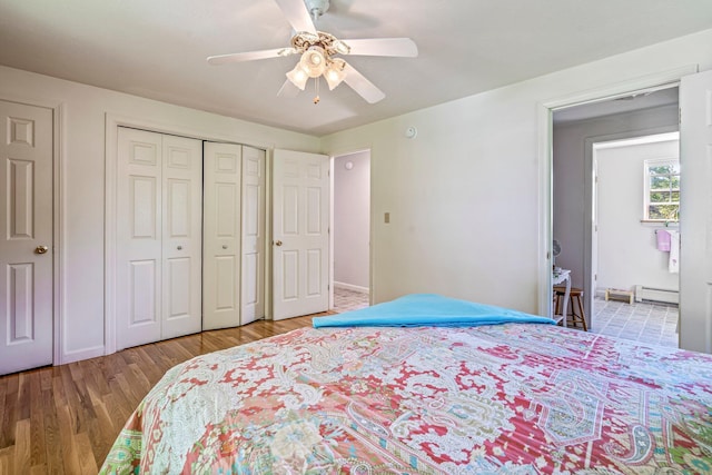 129 Lawrence Rd, Gray, ME 04039 - bedroom with wood finished floors, a baseboard heating unit, a closet, ceiling fan, and baseboards