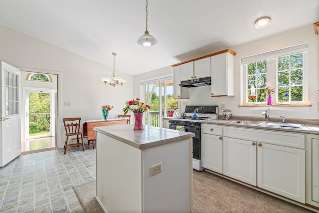 129 Lawrence Rd, Gray, ME 04039 - kitchen featuring range with gas cooktop, under cabinet range hood, a sink, lofted ceiling, and a chandelier