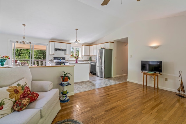 129 Lawrence Rd, Gray, ME 04039 - living area with light wood finished floors, lofted ceiling, a ceiling fan, a chandelier, and baseboards