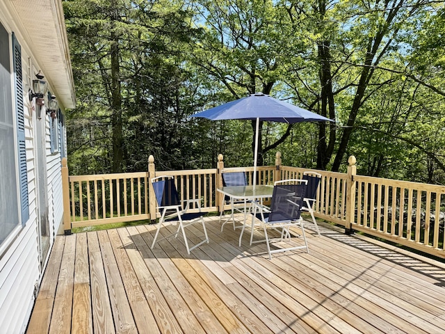 323 Main St S, Searsmont, ME 04973 - wooden deck featuring outdoor dining space and view of scattered trees