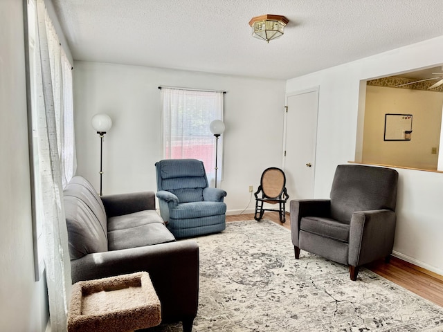 323 Main St S, Searsmont, ME 04973 - living room with wood finished floors, a textured ceiling, and baseboards