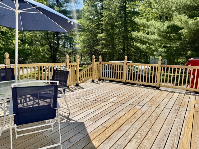 323 Main St S, Searsmont, ME 04973 - wooden terrace with outdoor dining area and view of wooded area