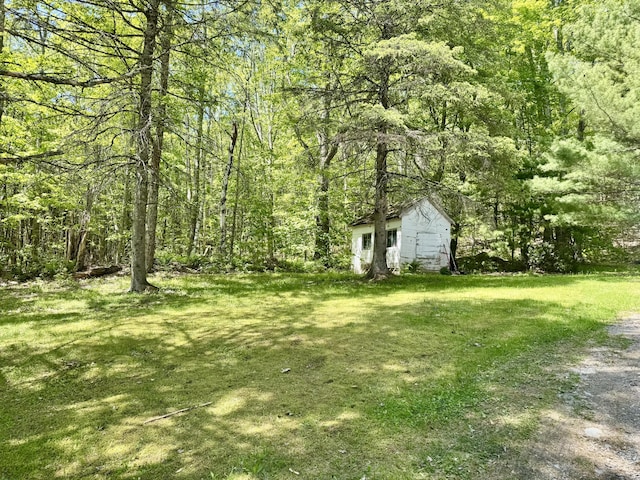 323 Main St S, Searsmont, ME 04973 - view of green lawn featuring a wooded view and an outdoor structure
