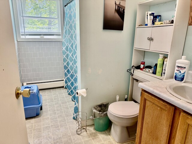 323 Main St S, Searsmont, ME 04973 - full bath with baseboard heating, toilet, vanity, and curtained shower