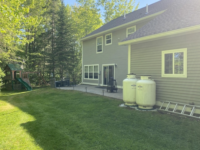 12 Cromwell Dr, Orono, ME 04473 - back of property with a patio, a yard, a playground, and roof with shingles