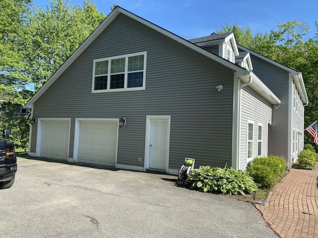12 Cromwell Dr, Orono, ME 04473 - view of home's exterior with a garage and asphalt driveway