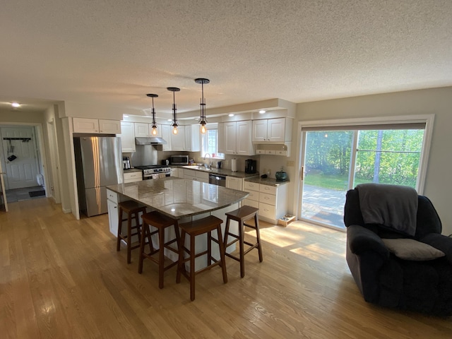 12 Cromwell Dr, Orono, ME 04473 - dining area with light wood-style flooring and a textured ceiling