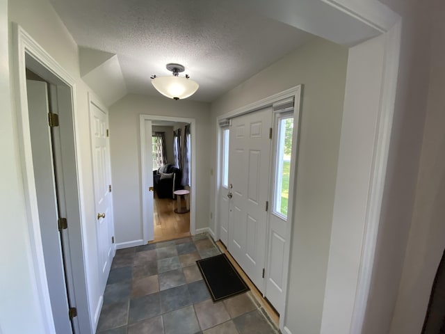 12 Cromwell Dr, Orono, ME 04473 - foyer entrance with plenty of natural light, a textured ceiling, and vaulted ceiling
