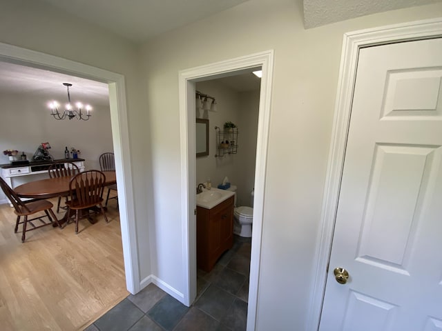 12 Cromwell Dr, Orono, ME 04473 - corridor with a sink and a chandelier