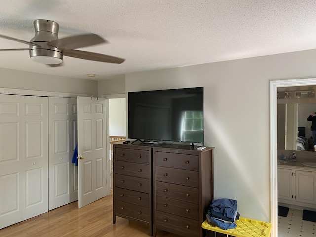 12 Cromwell Dr, Orono, ME 04473 - bedroom with a closet, a textured ceiling, light wood-style flooring, ceiling fan, and ensuite bathroom