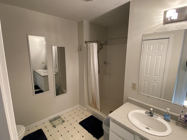 12 Cromwell Dr, Orono, ME 04473 - full bath with a stall shower, tile patterned floors, vanity, and a textured ceiling