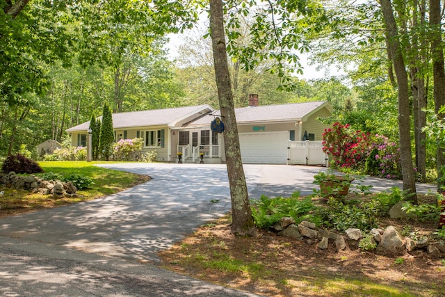 496 Coles Hill Rd, Wells, ME 04090 - single story home featuring asphalt driveway, a chimney, a garage, and a gate
