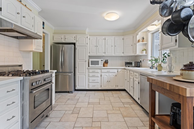 496 Coles Hill Rd, Wells, ME 04090 - kitchen featuring appliances with stainless steel finishes, crown molding, and white cabinetry