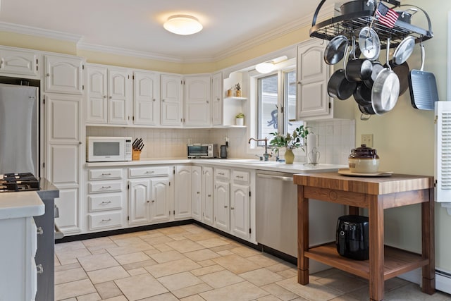496 Coles Hill Rd, Wells, ME 04090 - kitchen featuring dishwasher, white microwave, light countertops, decorative backsplash, and ornamental molding