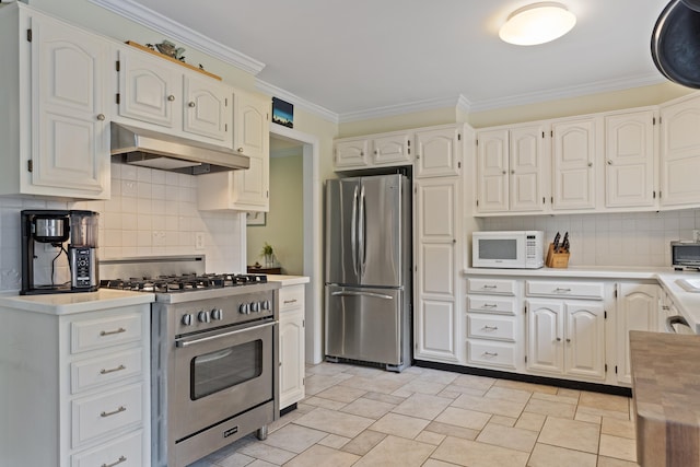496 Coles Hill Rd, Wells, ME 04090 - kitchen featuring stainless steel appliances, under cabinet range hood, backsplash, ornamental molding, and light countertops
