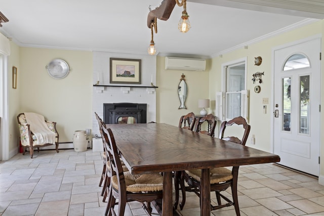 496 Coles Hill Rd, Wells, ME 04090 - dining space featuring a wall mounted air conditioner, stone tile flooring, crown molding, and a fireplace
