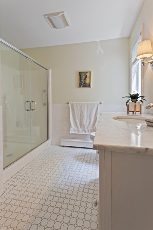 496 Coles Hill Rd, Wells, ME 04090 - full bath with vanity, a shower stall, a wainscoted wall, and tile walls