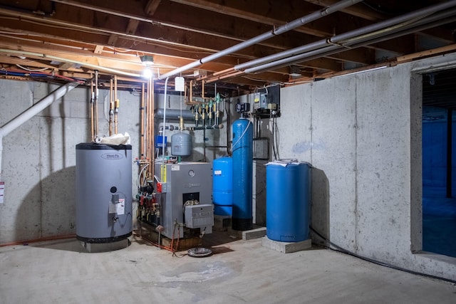 496 Coles Hill Rd, Wells, ME 04090 - unfinished basement with water heater, a heating unit, and a water pressure tank