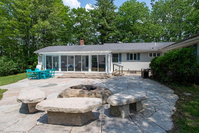 496 Coles Hill Rd, Wells, ME 04090 - rear view of property with a patio area, a chimney, and an outdoor fire pit