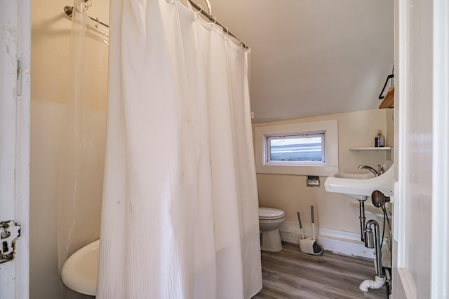 83 Brackett St, Portland, ME 04102 - full bath with wood finished floors, vaulted ceiling, and a shower with shower curtain
